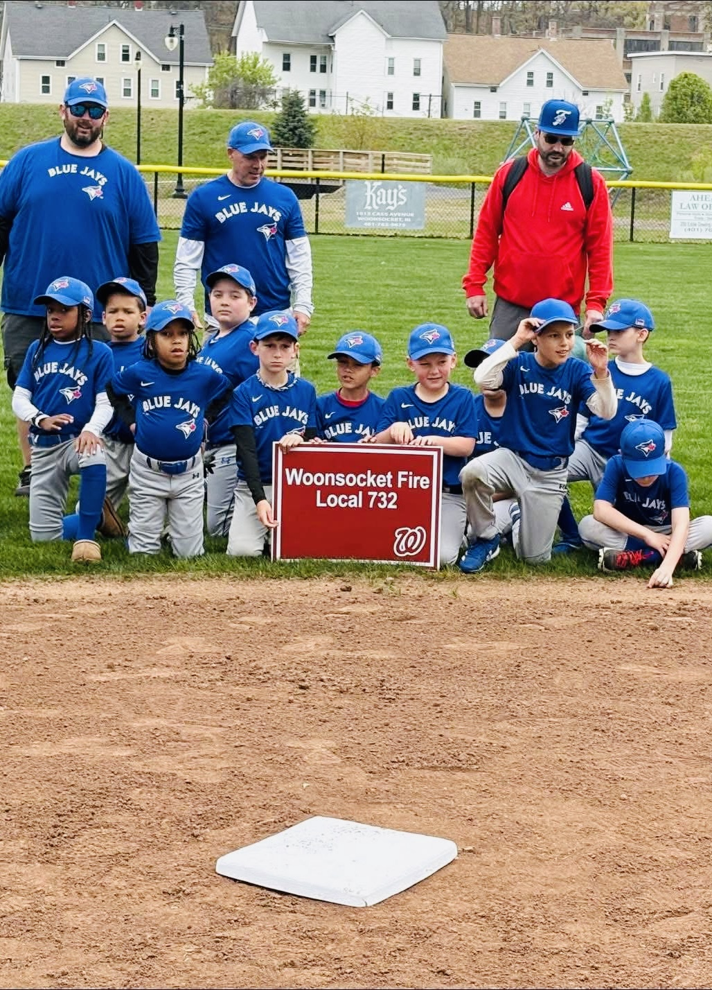 Youth baseball team in custom-printed jerseys, sponsored gear made by Print & Play
