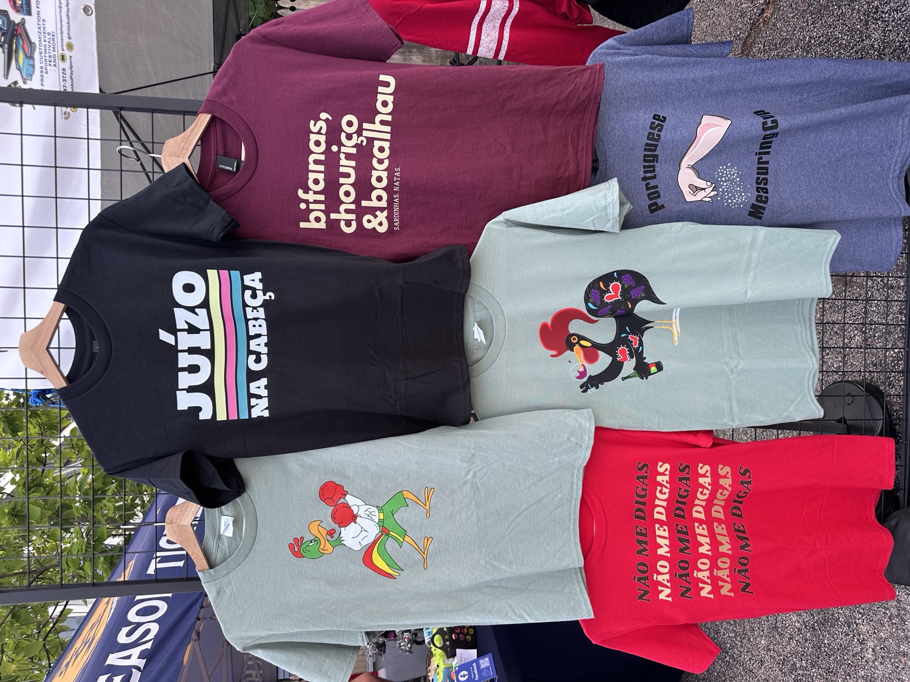 Custom-printed Portuguese-themed t-shirt designs on display